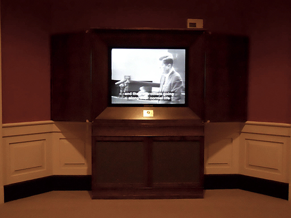 JFK Museum display featuring TV news clips of JFK