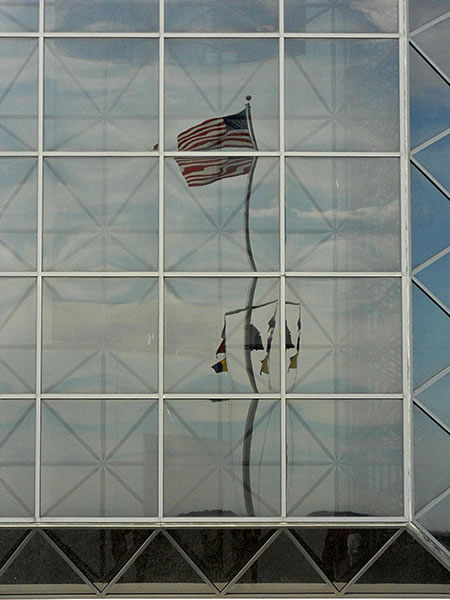 reflection of flag outside the JFK Library and Museum